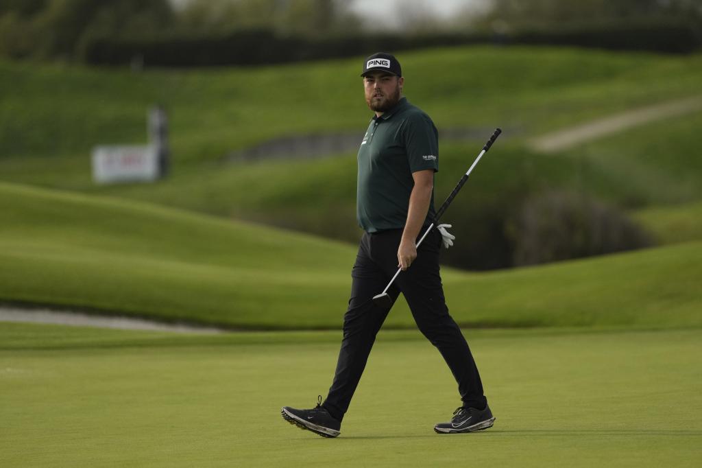 Dan Bradbury of England walks as he plays on the 18th hole during the Golf French Open at Le Golf National in Saint-Quentin-en-Yvelines.