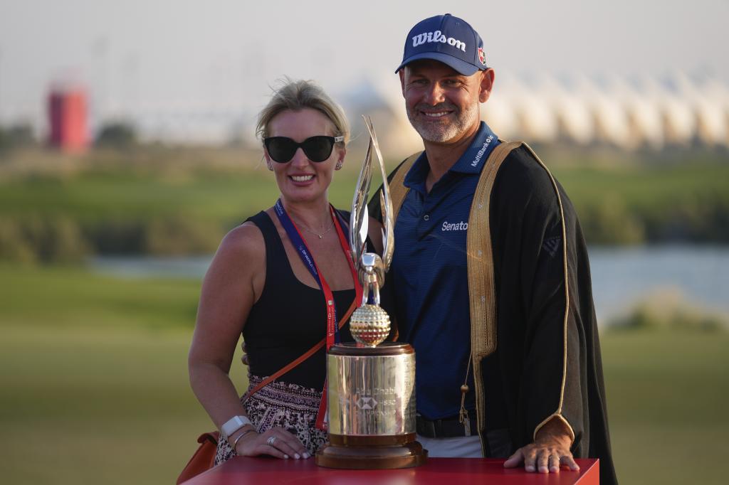 Paul Waring poses with his wife after the victory.