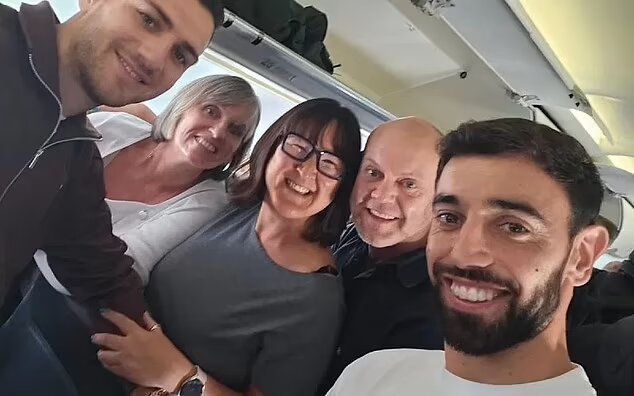 Bruno Fernandes with some passengers on the flight from Manchester to Lisbon