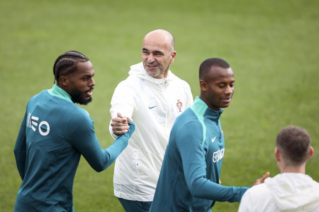 Nuno Tavares greets Roberto Martínez at the Portugal camp.