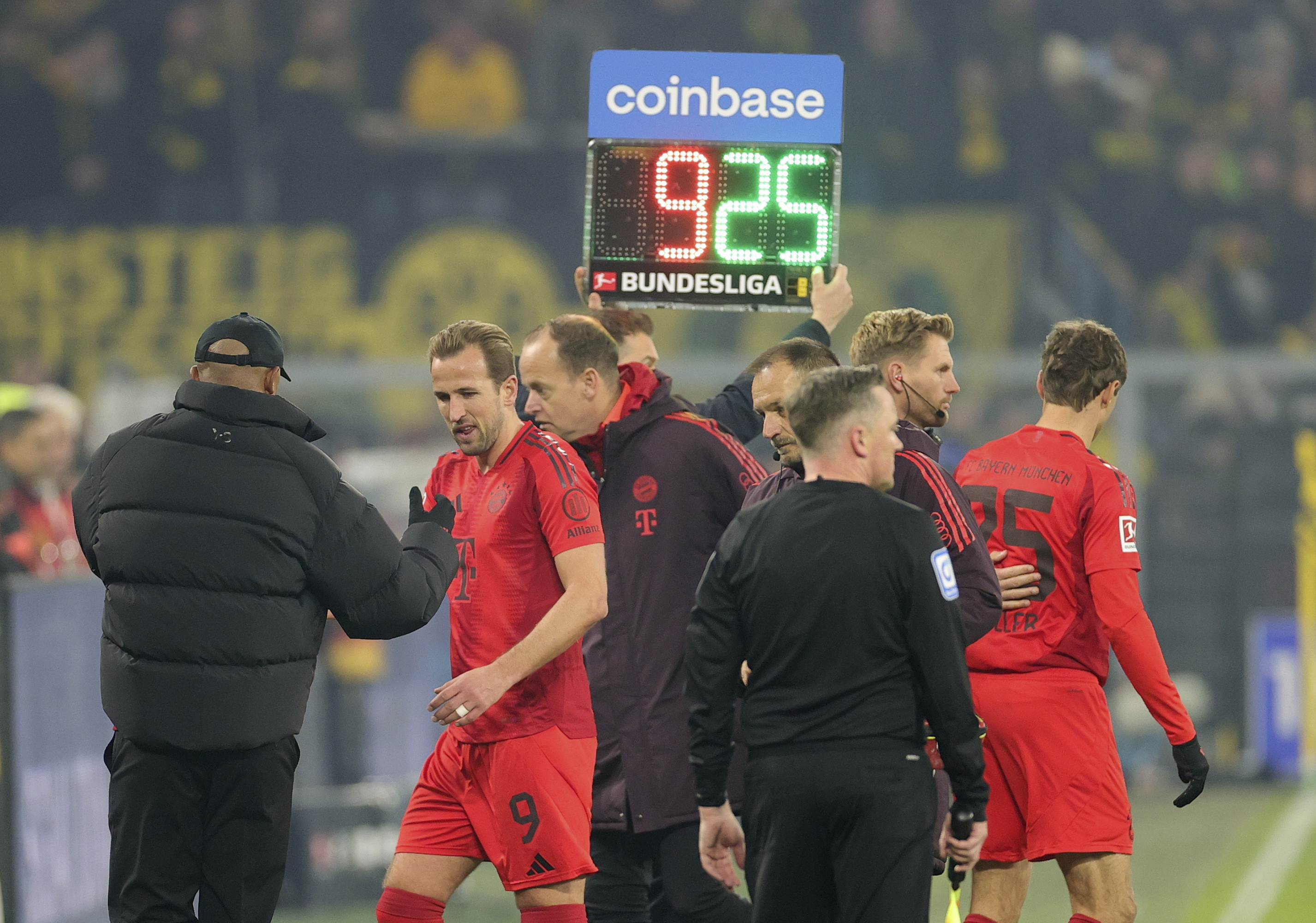 Harry Kane leaves the field injured in the Bundesliga match between his Bayern Munich and Borussia Dortmund