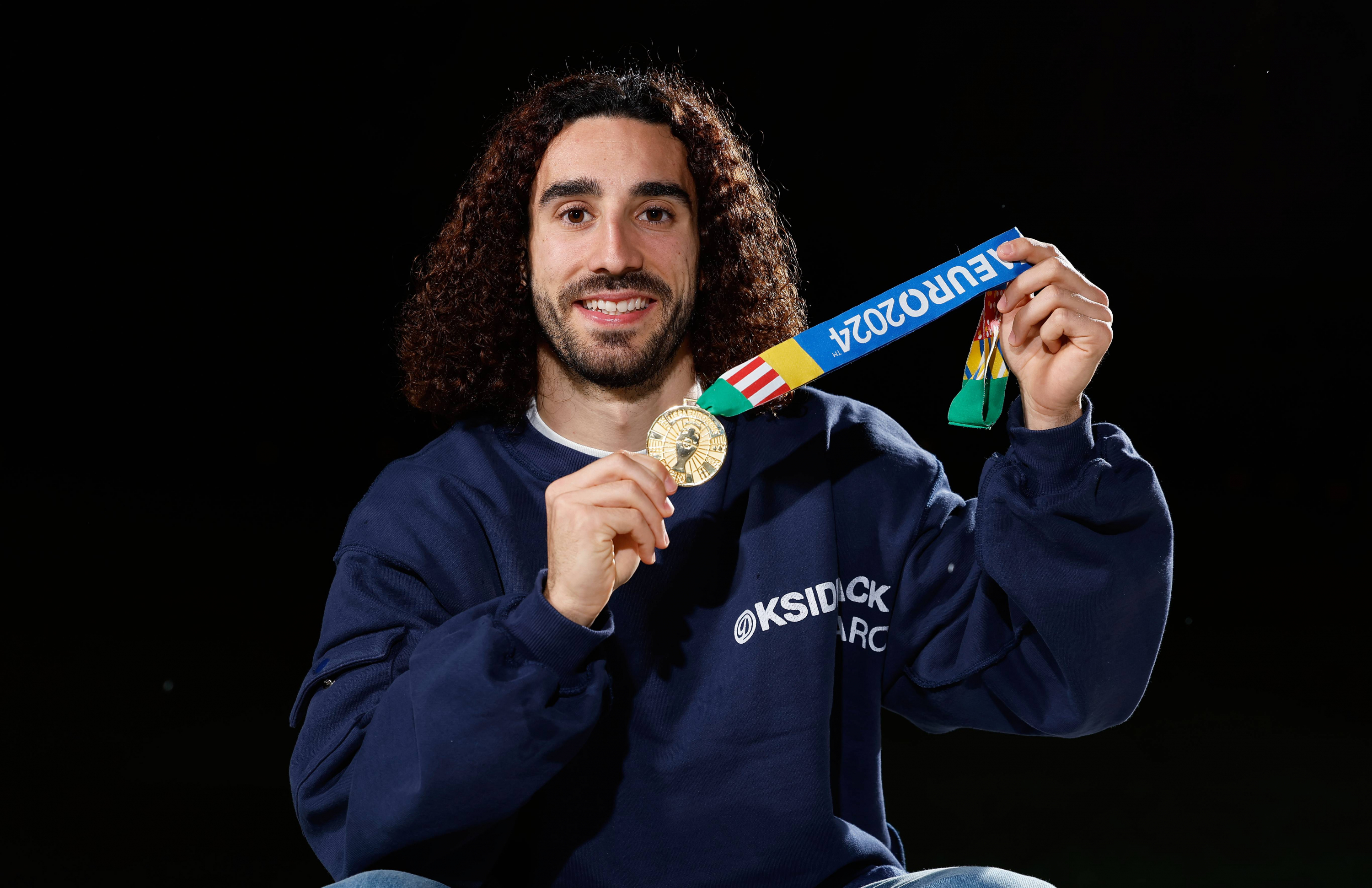 Cucurella poses for MARCA with his champion medal.